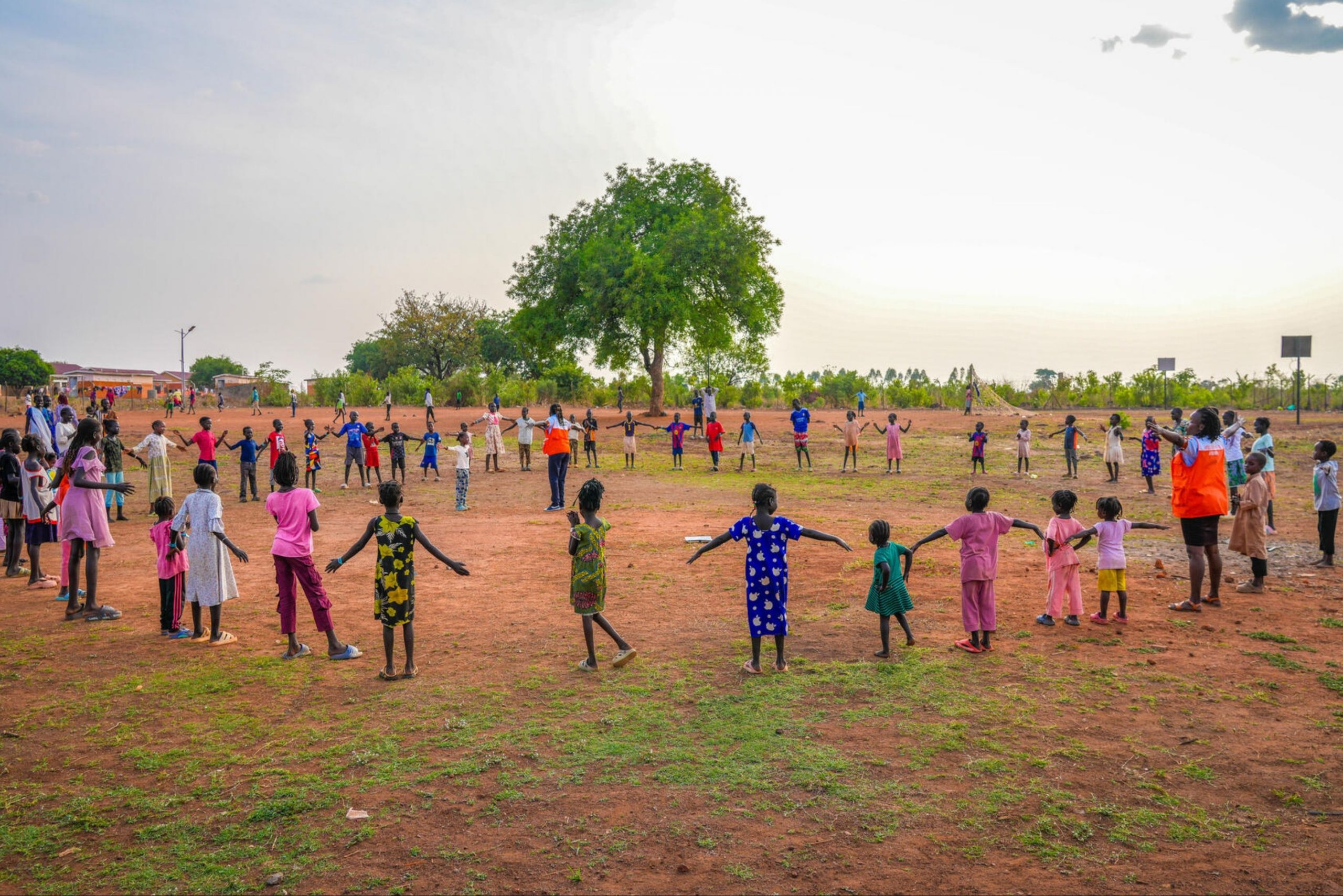 Kinderen in Oeganda lopen rondjes en spelen een spel