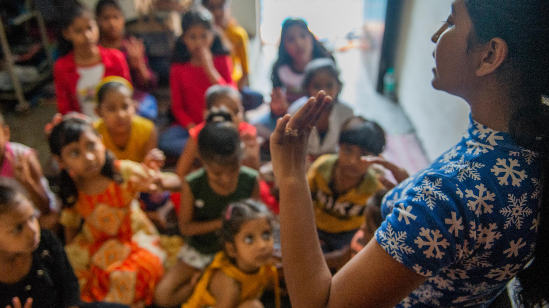 Meisje spreekt groep kinderen toe