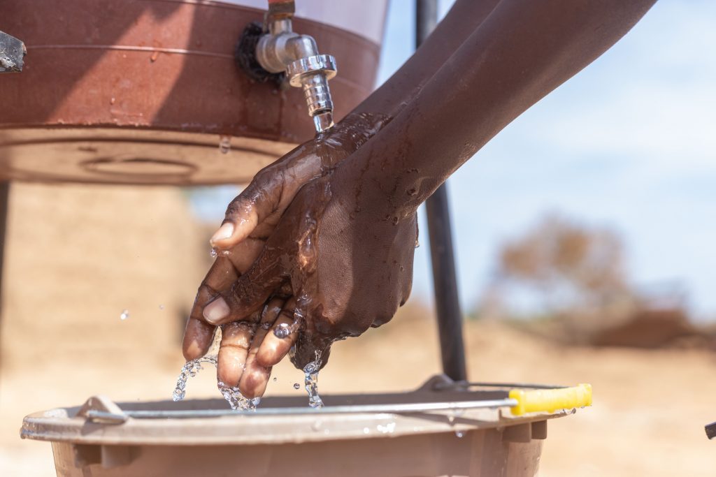 Handenwassen onder waterpunt van World Vision