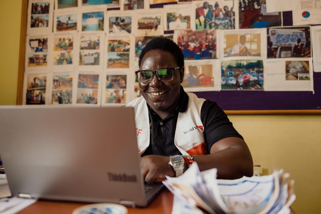 A World Vision employee in Tanzania hard at work at his desk