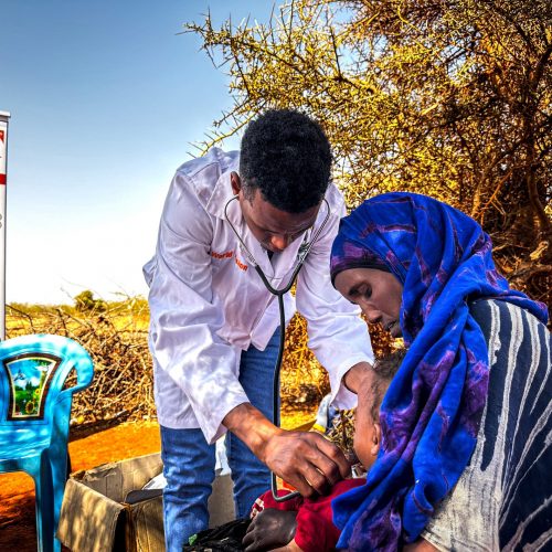 Gezondheidszorg gegeven door World Vision medewerker aan moeder en kind